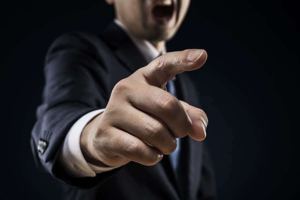 Businessman sticks out a finger and reproves it