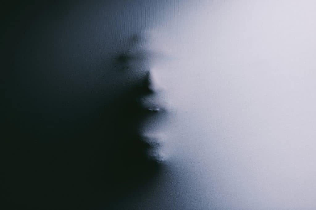 Shot of a scary figure confined under a sheet